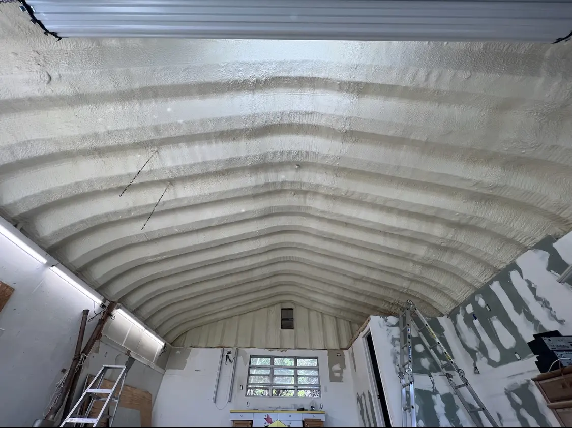 Spray polyurethane foam applied to the underside of a metal roof deck in Raisinville